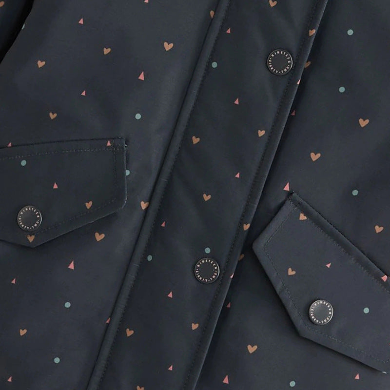 Close-up of snap-button front and flap pockets on girls navy heart print hooded jacket
