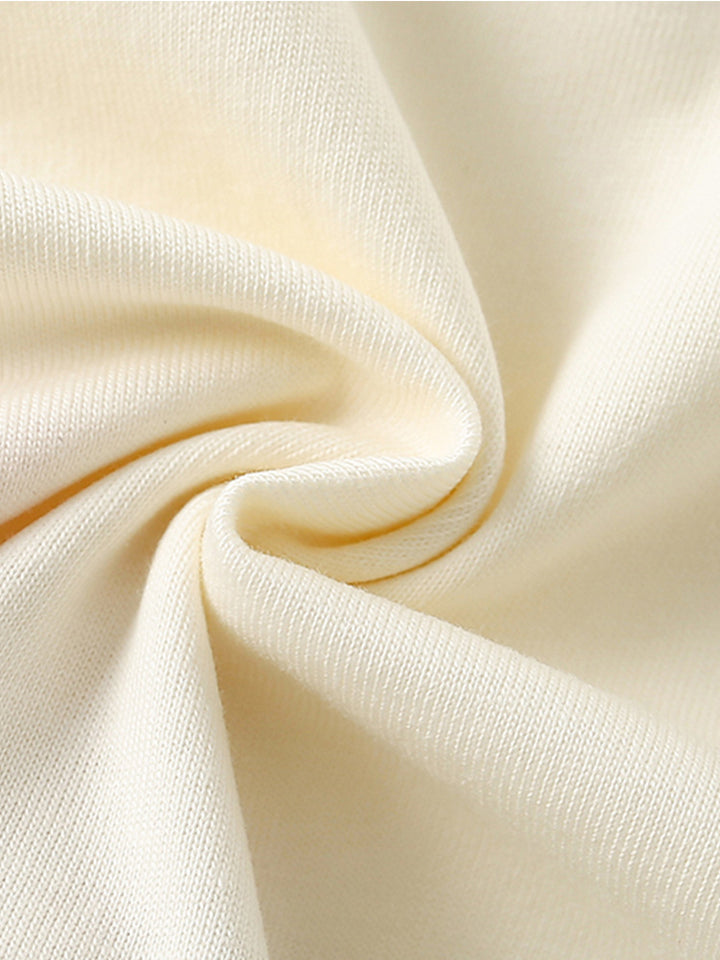 Close-up of the soft cotton-knit fabric of the Girls’ Sunshine Garden T-shirt