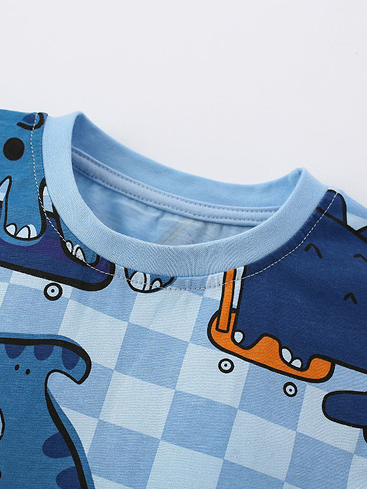 Close-up of the soft crew neckline on the Boys’ Dino Grid cotton pajama top