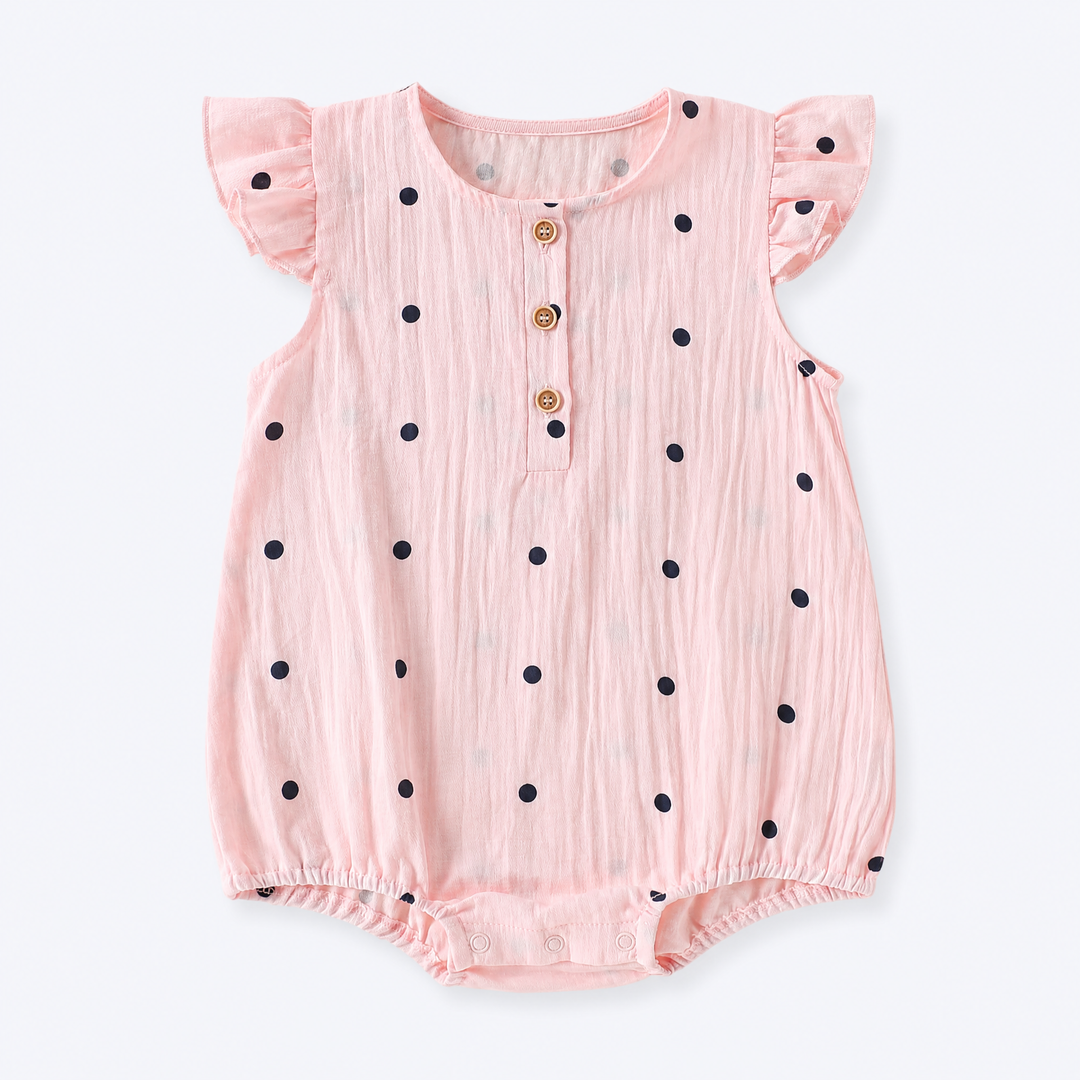 Blush pink baby girl polka dot ruffle sleeve cotton bodysuit on a pale blue-gray background