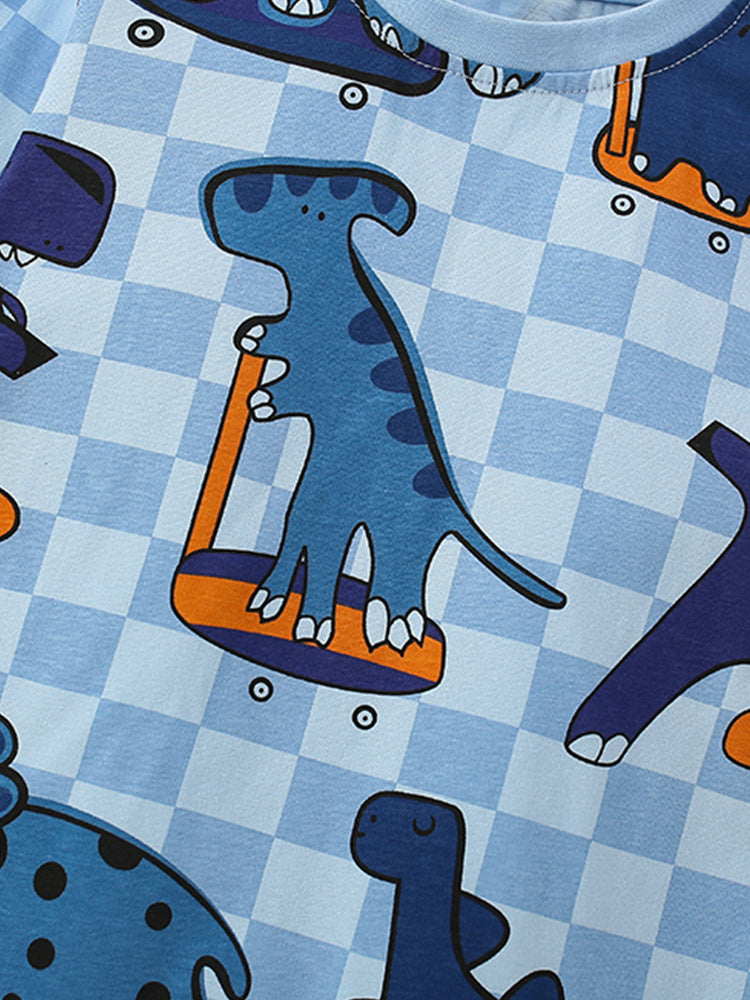 Close-up of the blue dinosaur checkerboard print on the Boys’ Dino Grid pajama set