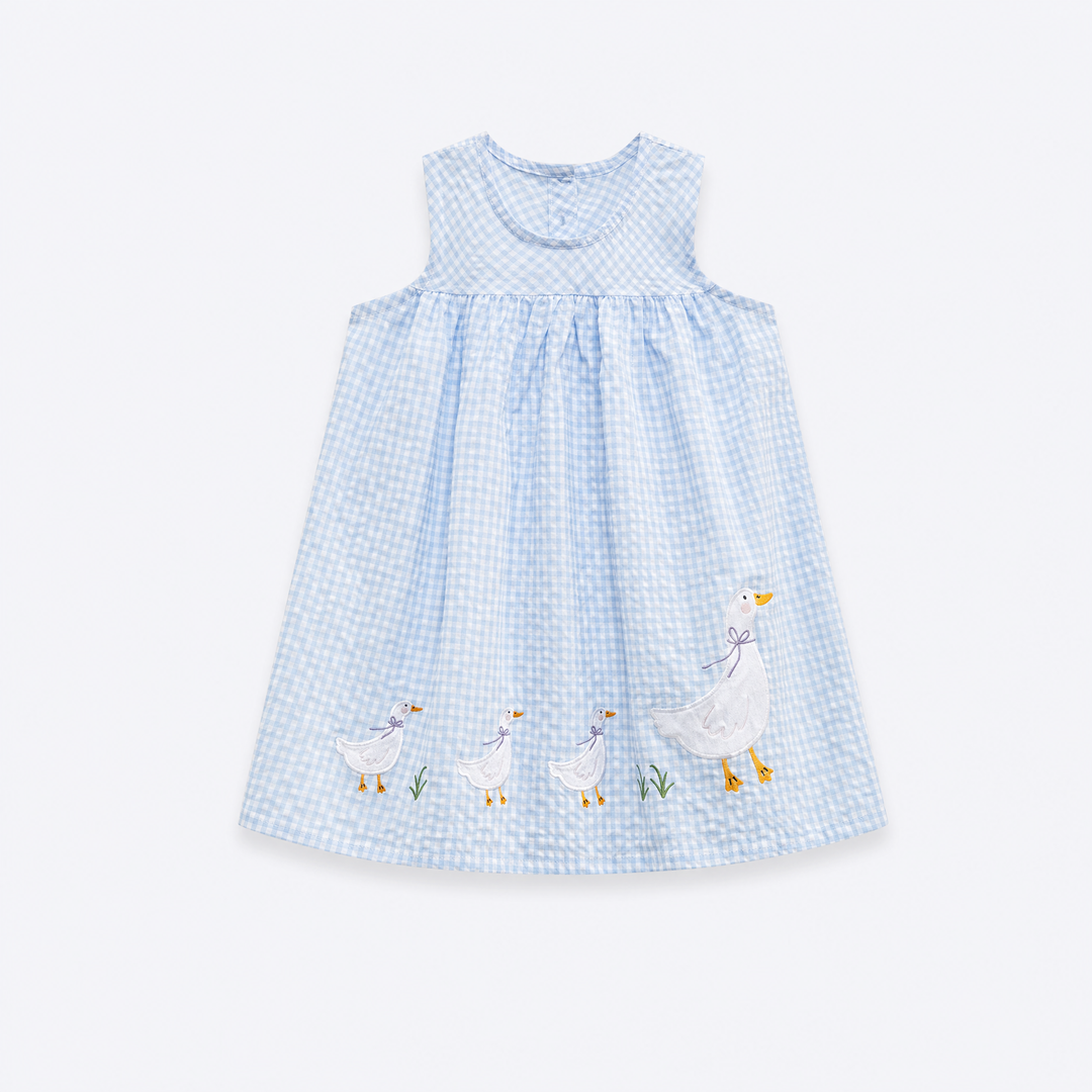 Sky blue gingham girls sleeveless dress with sharply detailed embroidered white geese on pale blue-gray background
