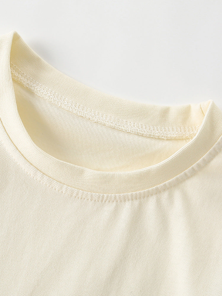 Close-up of the soft crew neckline on the Girls’ Sunshine Garden cotton T-shirt